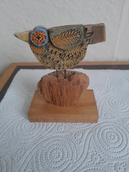 Studio crafted bird on a wooden base, JL mark .  20220627