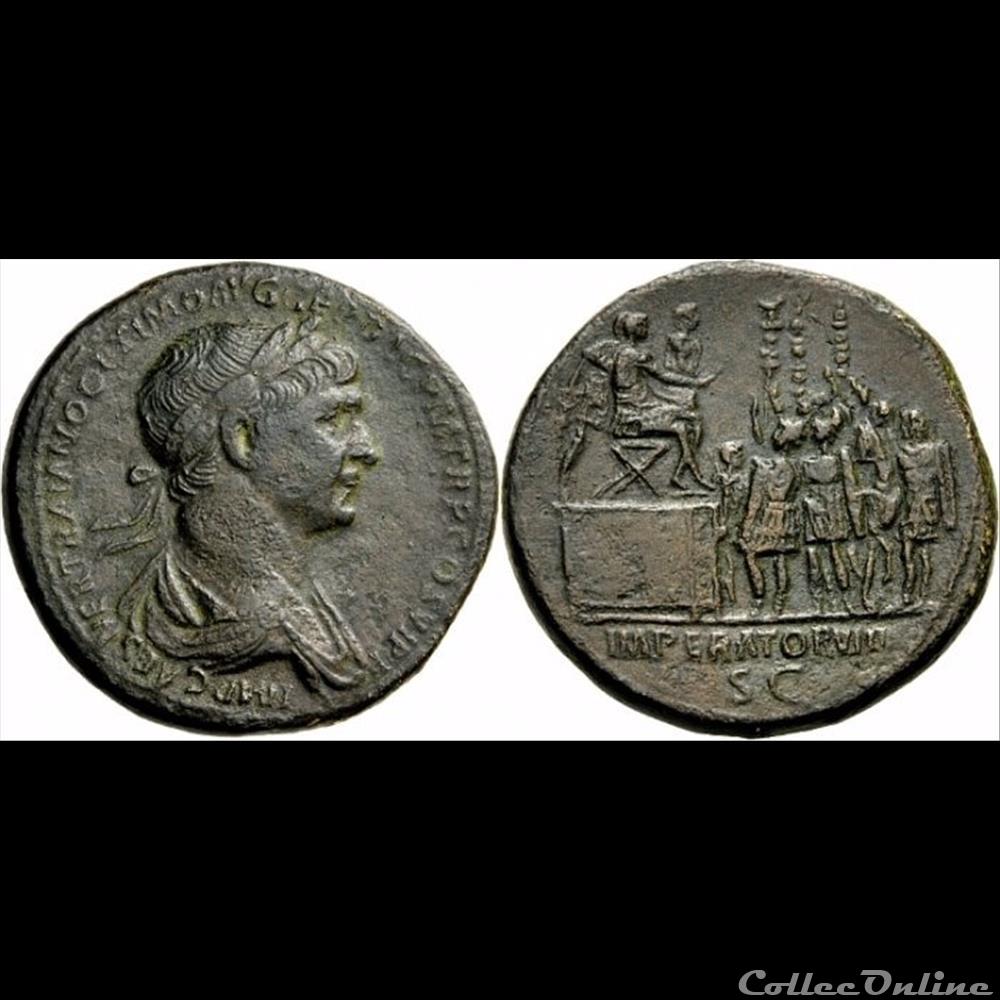 Sestercio de Trajano. IMPERATOR VIII / S C. Trajano sedente a dcha. sobre tribuna. Roma. Ric_6510