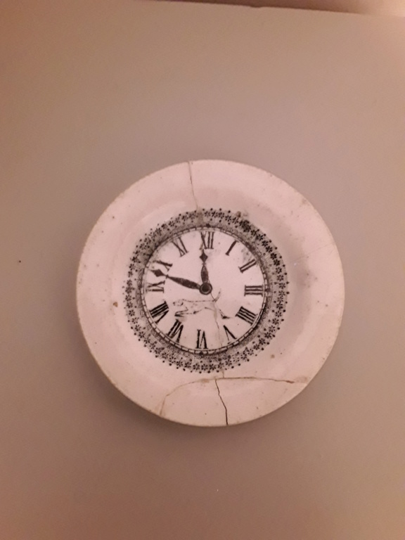 Small plate with clock face and dog in middle. 20200417