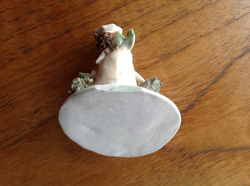Tiny unmarked porcelain figurine
