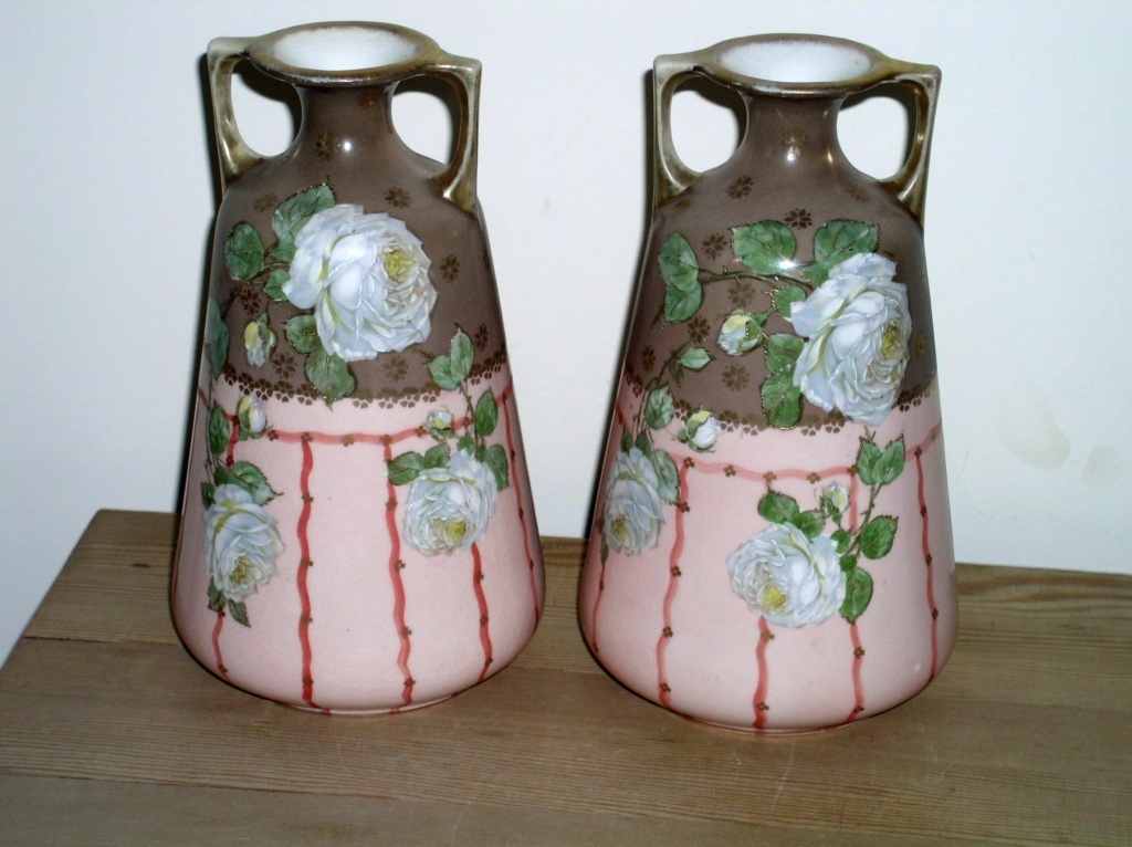 Unusual urn shaped two handled pair of vases with raised floral decoration  P1010362