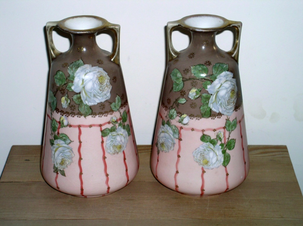 Unusual urn shaped two handled pair of vases with raised floral decoration  P1010363