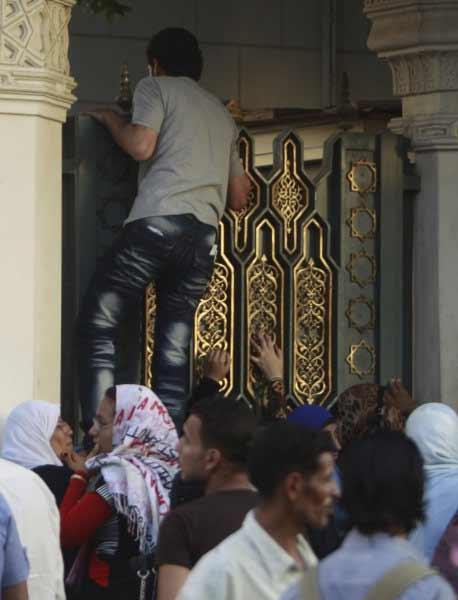 بالصور مصريون يحاولون القفز من أعلى أبواب قصر الرئاسة Alame161