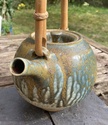 Teapot with impressed shells. tadpole or hook mark: Reid Ozaki, USA  F7731e10