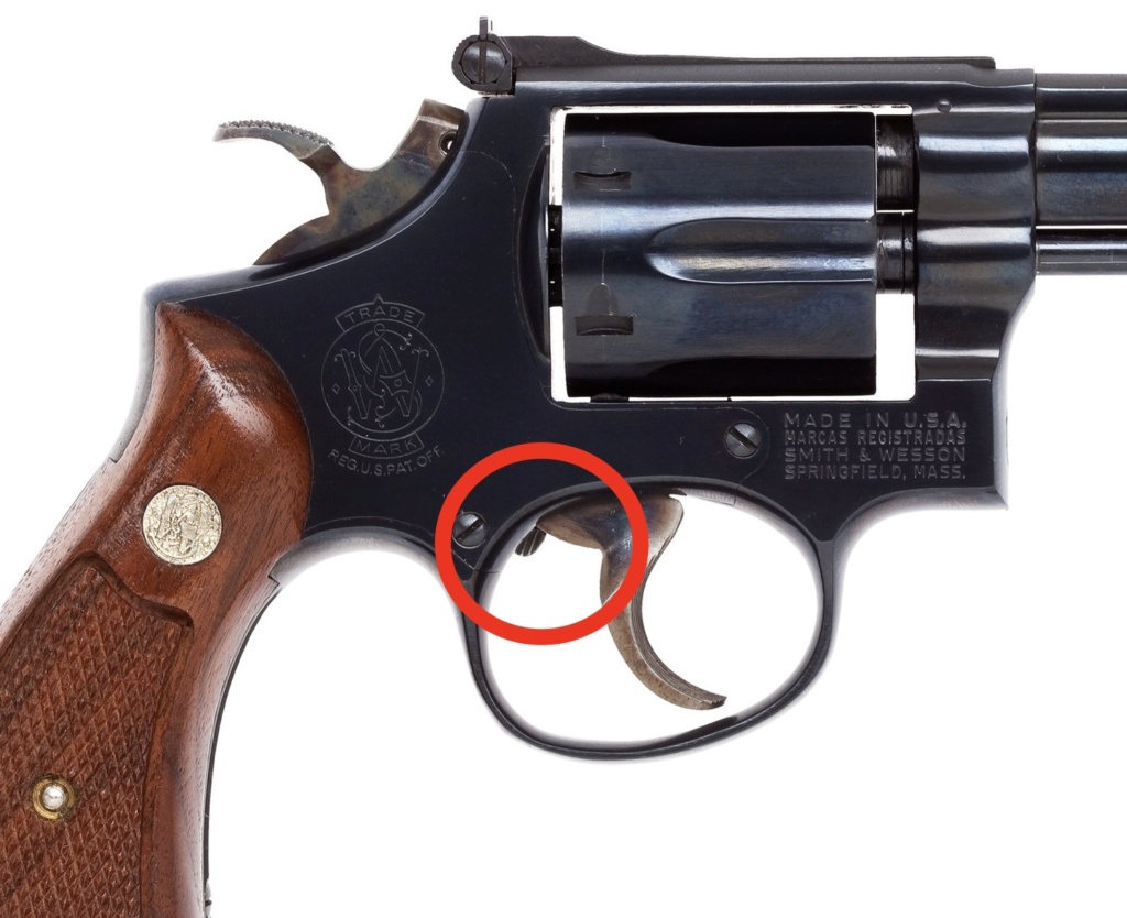 What is the function of a trigger over-travel screw on a revolver? 5b385f10