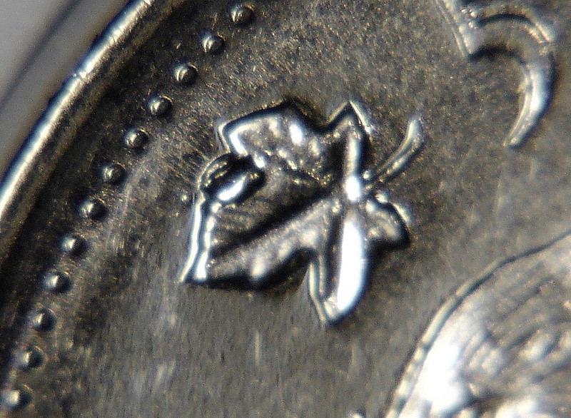2009 - Éclat de coin sur feuille gauche (Die chip on left leaf) Ca_0_703