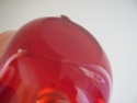 Red art glass centrepiece with label Pb100012