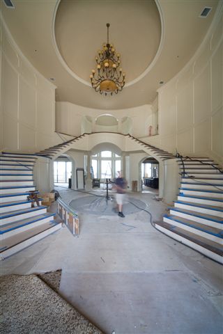 Grand 2-story foyer with double staircase (unfinished) Stairc13
