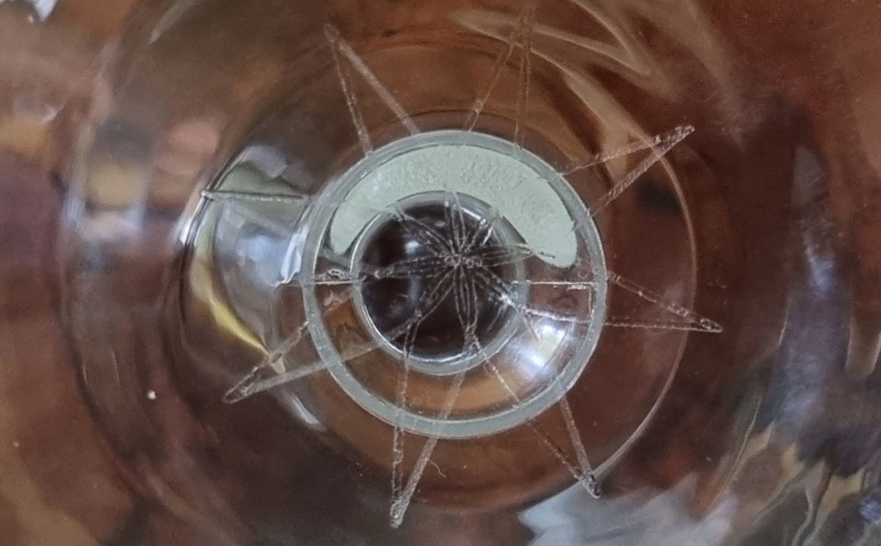 Etched 8 point Star Logo/Mark inside Champagne Coupe.  Co120210